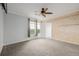 Comfortable bedroom featuring carpet floors, natural light, and modern wood wall; inviting space for rest at 13456 Via Varra # 401, Broomfield, CO 80020