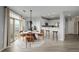 Open concept dining room featuring a modern table set with a view of the kitchen and exterior at 13456 Via Varra # 401, Broomfield, CO 80020