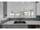 Modern kitchen with stainless steel appliances, and quartz countertops, open to living area for easy entertaining at 13456 Via Varra # 401, Broomfield, CO 80020