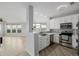 Bright kitchen featuring stainless steel appliances, quartz countertops, and gray backsplash, offering a modern look at 13456 Via Varra # 401, Broomfield, CO 80020