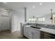 Open kitchen layout with white cabinets, stainless steel appliances, and tiled backsplash, creating a modern and functional space at 13456 Via Varra # 401, Broomfield, CO 80020