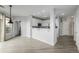 Bright kitchen with white cabinets, stainless appliances, and views of living room at 13456 Via Varra # 401, Broomfield, CO 80020