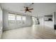 Bright living room with wood floors, ceiling fan, and lots of natural light with open kitchen at 13456 Via Varra # 401, Broomfield, CO 80020
