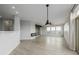 Bright living room with wood floors, accent wall, fireplace, ceiling fan, and lots of natural light at 13456 Via Varra # 401, Broomfield, CO 80020