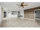 Bright living room with wood floors, accent wall, fireplace, ceiling fan, and kitchen view at 13456 Via Varra # 401, Broomfield, CO 80020