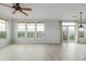 Bright living room featuring hard floors and multiple large windows offering lots of natural light at 13456 Via Varra # 401, Broomfield, CO 80020
