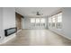 Bright living room with wood floors, accent wall, fireplace, ceiling fan, and lots of natural light at 13456 Via Varra # 401, Broomfield, CO 80020