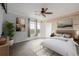 Tranquil bedroom with light wood accent wall, neutral decor, and ample natural light at 13456 Via Varra # 401, Broomfield, CO 80020