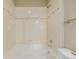 Bright shower tub with white tile and decorative accents, ready for relaxation and rejuvenation at 13456 Via Varra # 401, Broomfield, CO 80020