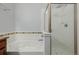 Bright shower tub with white tile and decorative accents and glass shower doors, ready for relaxation and rejuvenation at 13456 Via Varra # 401, Broomfield, CO 80020