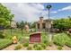 Welcoming Vantage Pointe community sign with manicured landscape, pool area, and trees at 13456 Via Varra # 401, Broomfield, CO 80020