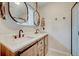 Elegant bathroom featuring double sinks, quartz countertops, and modern fixtures at 9303 W 66Th Pl, Arvada, CO 80004