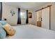 Well-lit bedroom featuring modern decor, and a sliding barn door to the bathroom at 9303 W 66Th Pl, Arvada, CO 80004