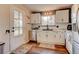 Updated kitchen featuring white cabinets and a stylish backsplash at 9303 W 66Th Pl, Arvada, CO 80004