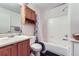 Full bathroom with tub, shower, vanity, and oak colored cabinets at 11120 Josephine Way, Northglenn, CO 80233