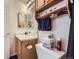 Well lit bathroom with wooden cabinets, vanity and mirror at 11120 Josephine Way, Northglenn, CO 80233