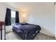 Cozy bedroom featuring a plush bed and ample natural light from the window at 11120 Josephine Way, Northglenn, CO 80233