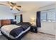 Comfortable bedroom with ceiling fan and natural light from a window at 11120 Josephine Way, Northglenn, CO 80233
