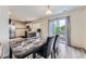 Stylish dining area with a sleek table and chairs, adjacent to the kitchen and sliding glass doors at 11120 Josephine Way, Northglenn, CO 80233