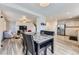 Open-concept dining area with a modern table and chairs, leading to the living room and kitchen at 11120 Josephine Way, Northglenn, CO 80233