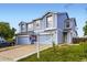 Well-lit exterior of a two-story townhome featuring a manicured lawn and inviting curb appeal at 11120 Josephine Way, Northglenn, CO 80233