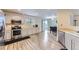Bright kitchen features stainless steel appliances and modern wood-look flooring at 11120 Josephine Way, Northglenn, CO 80233
