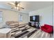 Bright living room featuring a modern ceiling fan, contemporary furniture, and hardwood floors at 11120 Josephine Way, Northglenn, CO 80233