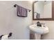 Cozy powder room features a pedestal sink and stylish fixtures at 11120 Josephine Way, Northglenn, CO 80233