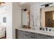 Modern bathroom with dual sinks, gray cabinets, and sleek black hardware at 1720 Wynkoop St # Ph403, Denver, CO 80202