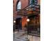 The well-lit building entrance features brickwork, an awning, and landscaping offering a welcoming entryway for residents at 1720 Wynkoop St # Ph403, Denver, CO 80202