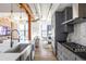 Open-concept kitchen boasts gray cabinetry, stainless steel appliances, and a farmhouse sink at 1720 Wynkoop St # Ph403, Denver, CO 80202