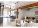 Spacious loft with exposed beams, hardwood floors, and a view into the kitchen at 1720 Wynkoop St # Ph403, Denver, CO 80202