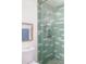 Stylish tiled shower with a handheld sprayer and refreshing showerhead at 1720 Wynkoop St # Ph403, Denver, CO 80202