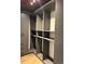 Spacious walk-in closet with custom shelving and gray cabinetry at 1720 Wynkoop St # Ph403, Denver, CO 80202