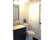 Cozy bathroom with a navy vanity, modern gold faucet, and contemporary fixtures at 12528 Ash St, Thornton, CO 80241