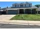 Inviting two-story home with a brick facade, attached garage, and a manicured front lawn at 12528 Ash St, Thornton, CO 80241