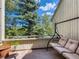 Inviting balcony featuring a comfortable swing and serene views of lush greenery at 2012 Tournament Ct, Evergreen, CO 80439