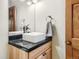 Bright bathroom featuring a black granite countertop and square porcelain sink at 2012 Tournament Ct, Evergreen, CO 80439
