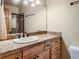 Bright bathroom featuring a granite countertop, single sink vanity, and natural light at 2012 Tournament Ct, Evergreen, CO 80439