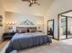 Bright bedroom with large windows, mountain artwork and neutral decor at 2012 Tournament Ct, Evergreen, CO 80439