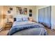 Comfortable bedroom featuring a large window and bed with blue accents at 2012 Tournament Ct, Evergreen, CO 80439