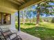 Enjoy a serene view from the covered patio of a lush, grassy yard and mature trees at 2012 Tournament Ct, Evergreen, CO 80439