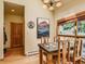 Cozy dining area with a stone table, wood chairs, and a view of the outdoors at 2012 Tournament Ct, Evergreen, CO 80439