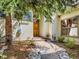 Charming home entrance with stone path, mature trees, and a wooden front door at 2012 Tournament Ct, Evergreen, CO 80439
