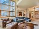 Open living room featuring vaulted ceilings, large windows, and comfortable seating at 2012 Tournament Ct, Evergreen, CO 80439