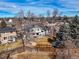 The house is set amid mature trees and fenced backyards in the suburban landscape at 7862 W Euclid Pl, Littleton, CO 80123