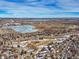 Community aerial view showcases proximity to lakes, parks, and residential areas under a vibrant, blue sky at 7862 W Euclid Pl, Littleton, CO 80123