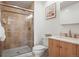 Bathroom features a tiled shower with glass door, modern toilet and vanity, and a neutral color scheme at 7862 W Euclid Pl, Littleton, CO 80123