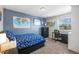 Stylish bedroom with blue walls, study desk, and snowflake comforter, blending sleep and study at 7862 W Euclid Pl, Littleton, CO 80123