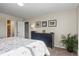 Bright bedroom features a floral bedspread, dark dresser, and tasteful decor, creating a welcoming atmosphere at 7862 W Euclid Pl, Littleton, CO 80123